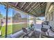 Inviting outdoor patio with cozy seating, dining area, and sunshades overlooking the yard at 80 E Texas Ave, Henderson, NV 89015