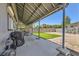 Spacious covered patio with seating area and views of the backyard with artificial turf at 80 E Texas Ave, Henderson, NV 89015