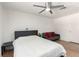 Bright bedroom featuring wood-look floors, a ceiling fan, and neutral walls, complete with a gray futon at 8600 W Charleston Blvd # 2085, Las Vegas, NV 89117