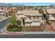 Aerial view of a charming two-story home featuring a well-manicured lawn, and a two-car garage at 8970 Lansberry Ct, Las Vegas, NV 89147