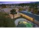 Aerial shot of home showcasing the backyard pool, landscaping, and surrounding neighborhood at 8970 Lansberry Ct, Las Vegas, NV 89147