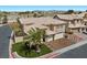 Aerial view of a charming two-story home featuring a well-manicured lawn, and a two-car garage at 8970 Lansberry Ct, Las Vegas, NV 89147