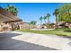 Expansive backyard with a covered patio, built-in grill, and manicured landscaping at 8970 Lansberry Ct, Las Vegas, NV 89147