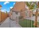 The backyard features artificial grass, a shed and a well maintained fence at 8970 Lansberry Ct, Las Vegas, NV 89147