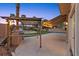 Covered outdoor kitchen area with grill and view of the backyard pool and landscaping at 8970 Lansberry Ct, Las Vegas, NV 89147