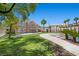 Lush backyard with a custom pool, mature trees, and a spacious lawn under a clear blue sky at 8970 Lansberry Ct, Las Vegas, NV 89147