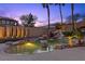 Gorgeous backyard pool with rock waterfall, lush landscaping, and a tranquil ambiance perfect for relaxation and entertaining at 8970 Lansberry Ct, Las Vegas, NV 89147