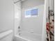 Clean and well-lit bathroom with a white tiled shower and a floral patterned curtain at 8970 Lansberry Ct, Las Vegas, NV 89147