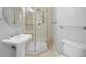 Bathroom features a pedestal sink, walk-in shower with glass door, and neutral tile at 8970 Lansberry Ct, Las Vegas, NV 89147