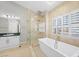This luxurious bathroom boasts a soaking tub, glass shower, and elegant tile work at 8970 Lansberry Ct, Las Vegas, NV 89147