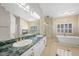 The spacious primary bathroom features dual sinks, a glass shower, and a soaking tub at 8970 Lansberry Ct, Las Vegas, NV 89147