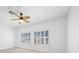 Neutral bedroom with a ceiling fan and shuttered windows at 8970 Lansberry Ct, Las Vegas, NV 89147