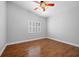Laminate flooring, shutters, and ceiling fan featured in this inviting bedroom space at 8970 Lansberry Ct, Las Vegas, NV 89147
