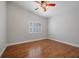 A simple bedroom with laminate floors and a window with white shutters at 8970 Lansberry Ct, Las Vegas, NV 89147