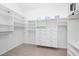 Bright walk-in closet with built-in shelving and hanging rods at 8970 Lansberry Ct, Las Vegas, NV 89147