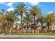 A beautifully landscaped entrance to the Granada Hills community with a decorative sign and palm trees at 8970 Lansberry Ct, Las Vegas, NV 89147