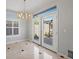 Well-lit dining area features a modern chandelier and French doors leading to an outdoor space at 8970 Lansberry Ct, Las Vegas, NV 89147