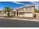 Charming two-story home featuring a well-manicured lawn, a palm tree, and a two-car garage at 8970 Lansberry Ct, Las Vegas, NV 89147