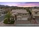 Charming two-story home with mature trees, a two-car garage, and a welcoming front porch at 8970 Lansberry Ct, Las Vegas, NV 89147