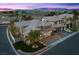 Beautiful two-story home featuring lush landscaping, a multi-car garage, and a brick driveway at 8970 Lansberry Ct, Las Vegas, NV 89147