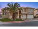 A well-maintained two-story home with a tile roof, manicured landscaping, and a two-car garage at 8970 Lansberry Ct, Las Vegas, NV 89147