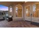 Inviting front porch featuring tile flooring, seating area, and decorative glass front doors at 8970 Lansberry Ct, Las Vegas, NV 89147