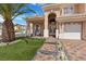 Inviting front porch with stone pavers, ample seating, and beautiful landscaping at 8970 Lansberry Ct, Las Vegas, NV 89147