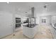 Bright kitchen features stainless steel appliances, granite countertops, and center island with cooktop at 8970 Lansberry Ct, Las Vegas, NV 89147