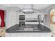 Island in the kitchen with cooktop, stainless steel appliances, and modern vent hood at 8970 Lansberry Ct, Las Vegas, NV 89147