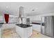 Modern kitchen features an island with a gas cooktop, stainless appliances, and ample cabinet space at 8970 Lansberry Ct, Las Vegas, NV 89147