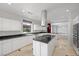 Well-lit kitchen features granite counters, white cabinets, a center island, and stainless appliances at 8970 Lansberry Ct, Las Vegas, NV 89147