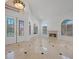 Bright living room features tile floors, fireplace, cathedral ceiling, and arched windows at 8970 Lansberry Ct, Las Vegas, NV 89147