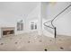 Bright, open living room features a fireplace and a winding staircase to the upper level at 8970 Lansberry Ct, Las Vegas, NV 89147