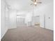 Bright, open living room has neutral carpet, modern lighting, and view to other living areas at 8970 Lansberry Ct, Las Vegas, NV 89147