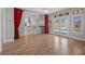 Open-concept living room with hardwood floors, backyard access, and views of the kitchen at 8970 Lansberry Ct, Las Vegas, NV 89147