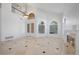 Bright living room features tile floors, fireplace, cathedral ceiling, and arched windows at 8970 Lansberry Ct, Las Vegas, NV 89147