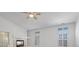 Living room with a fireplace, ceiling fan, and windows with white shutters at 8970 Lansberry Ct, Las Vegas, NV 89147