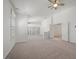 Large living room with white walls, neutral carpet, and many shuttered windows at 8970 Lansberry Ct, Las Vegas, NV 89147