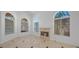 Bright living room features tile floors, fireplace, cathedral ceiling, and arched windows at 8970 Lansberry Ct, Las Vegas, NV 89147