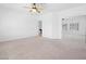 Expansive main bedroom, with neutral carpet, mirrored closet, and a view into the game room at 8970 Lansberry Ct, Las Vegas, NV 89147