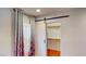 Bedroom closet with sliding barn door, next to a window with patterned curtains for natural light and privacy at 9116 Tailor Made Ave, Las Vegas, NV 89149