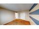 Relaxing bedroom featuring soft carpet, neutral walls with painted stripes, and convenient closet space at 9116 Tailor Made Ave, Las Vegas, NV 89149