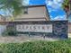 Stone sign for Tapestry by Astoria Homes with landscaping in a bright, sunny, residential neighborhood at 9116 Tailor Made Ave, Las Vegas, NV 89149