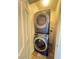 This laundry area includes a stacked washer and dryer unit, maximizing space at 9116 Tailor Made Ave, Las Vegas, NV 89149