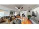 The bright living room is furnished with hardwood floors and a ceiling fan at 9116 Tailor Made Ave, Las Vegas, NV 89149