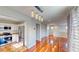 Open-concept floor plan with hardwood floors connecting the kitchen and living areas at 9116 Tailor Made Ave, Las Vegas, NV 89149