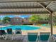 Community pool with lounge chairs and lush landscaping offers relaxation and recreation at 9116 Tailor Made Ave, Las Vegas, NV 89149