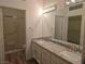 Bathroom with a double granite vanity, large mirror, and a separate room for the toilet and shower at 9329 Fresh Spring Dr, Las Vegas, NV 89134
