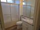 Bathroom showcasing a granite vanity, toilet, and shower-tub combination with sliding glass doors at 9329 Fresh Spring Dr, Las Vegas, NV 89134