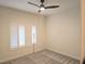 Bedroom with gray carpet, a ceiling fan, and plantation shutters at 9329 Fresh Spring Dr, Las Vegas, NV 89134